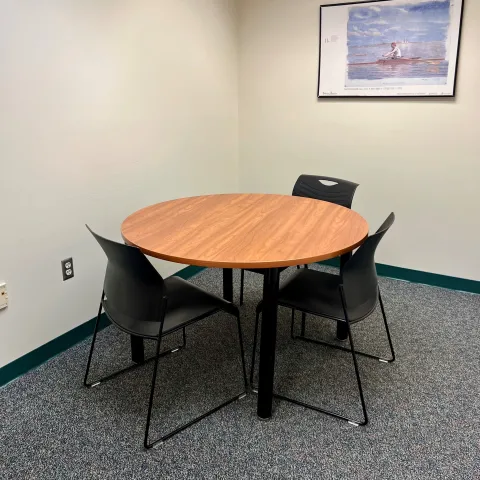 Small Study room with round table that seats four people. 