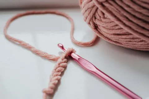 pink yarn with pink crochet hook and a few chain stiches