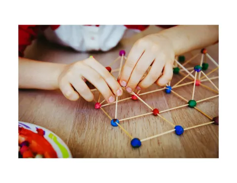 Children building with toothpicks and playdough.