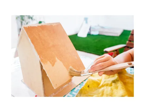 Painting a birdhouse.