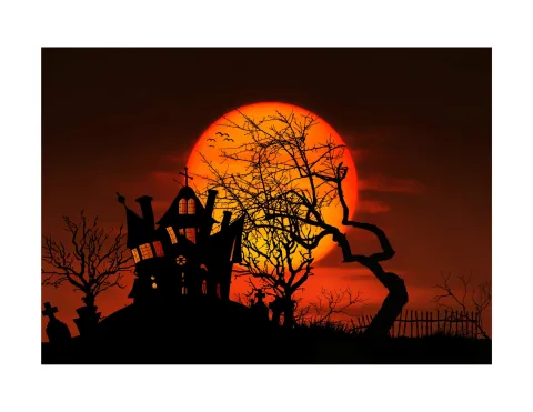 Orange background with black haunted house and trees.